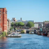 Beautiful view of a canal surrounded by buildings and boats in Bristol, England.